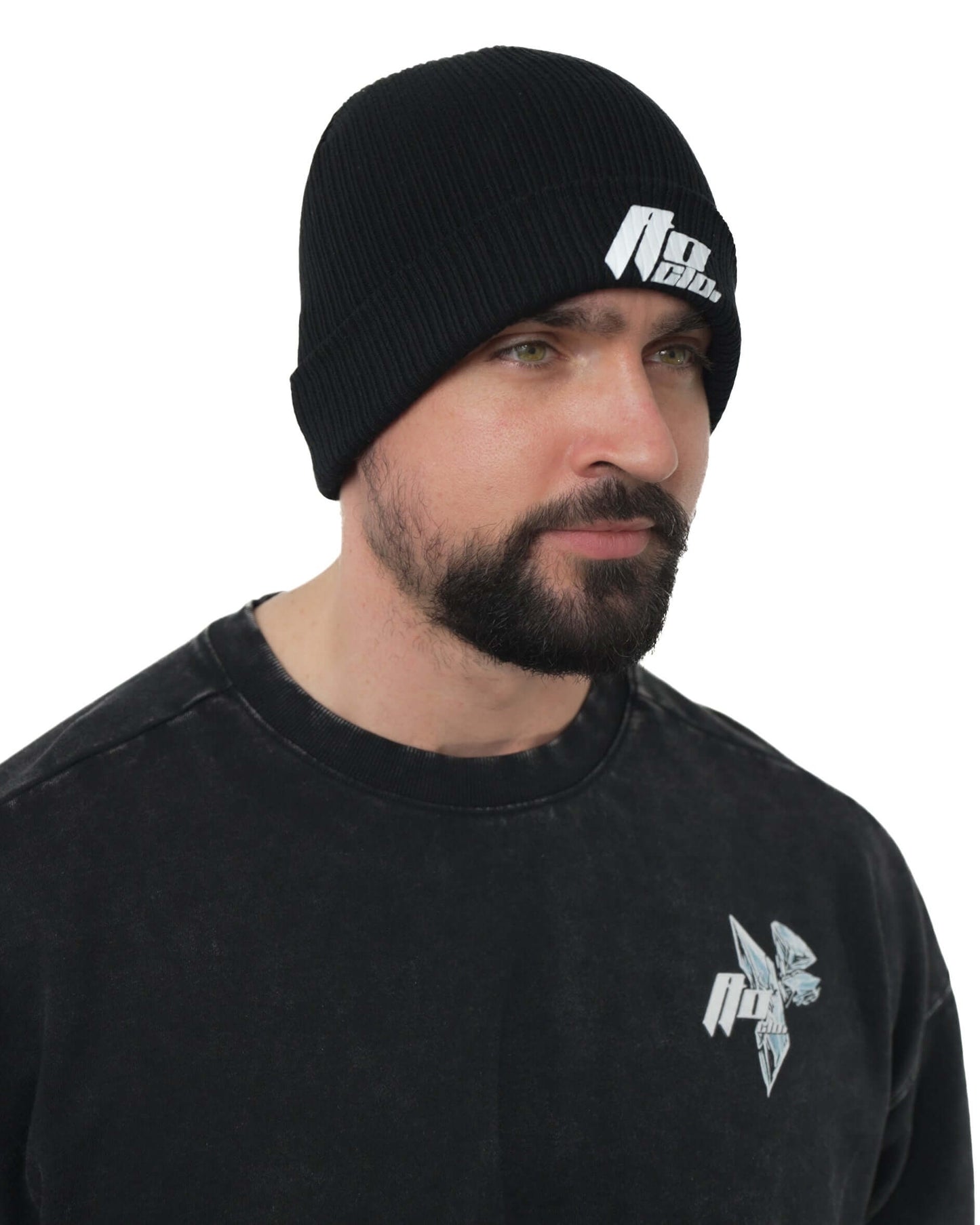 Male model wearing a black ICEBREAKER beanie, showcasing its comfortable knit and stylish design.